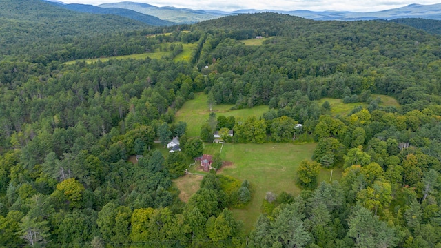 birds eye view of property with a mountain view and a wooded view