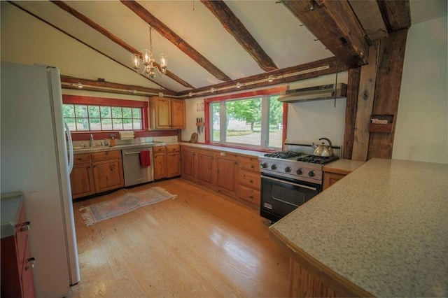 kitchen featuring vaulted ceiling with beams, under cabinet range hood, stainless steel appliances, light countertops, and light wood-type flooring