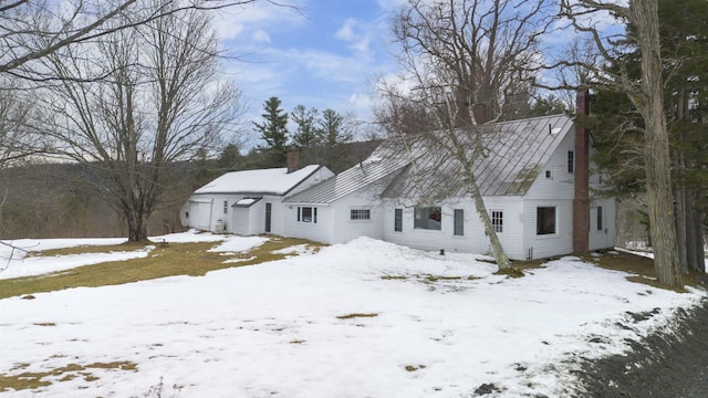 view of front of property featuring a garage and a chimney