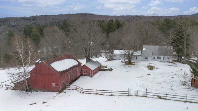 snowy aerial view with a forest view