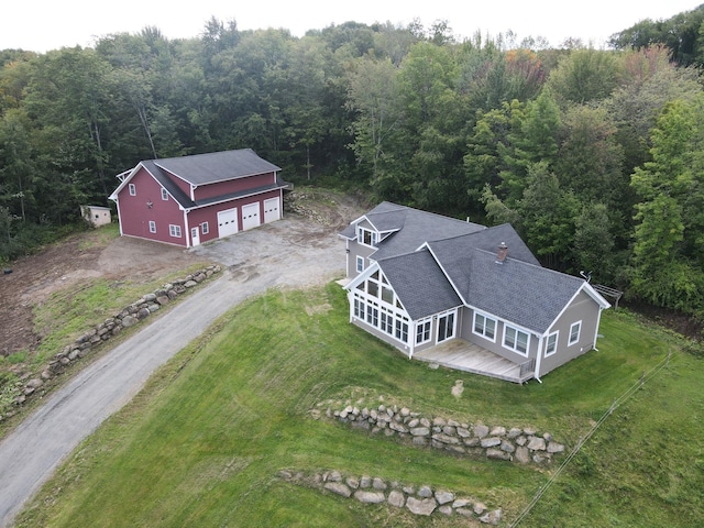 birds eye view of property with a wooded view