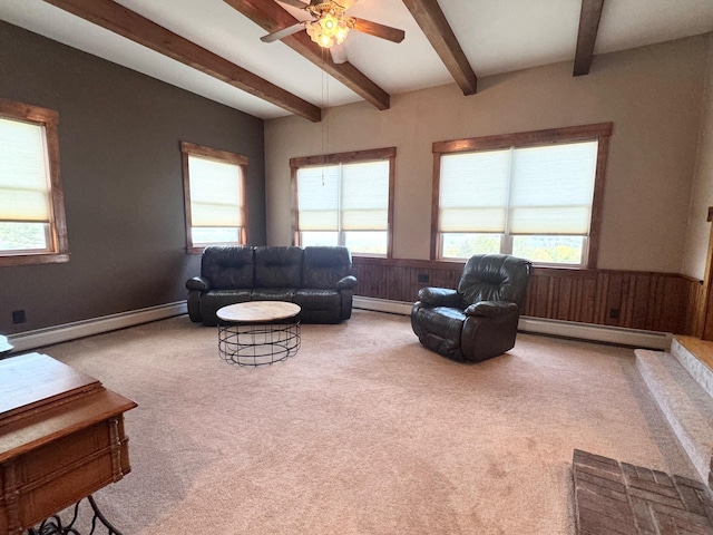 living room featuring a baseboard heating unit, wainscoting, and carpet flooring