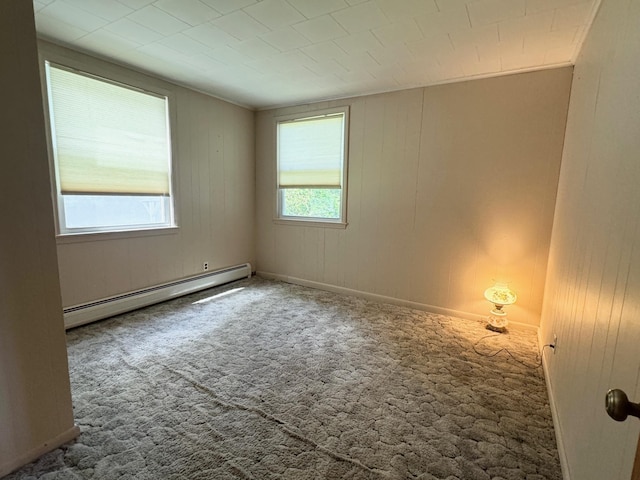 carpeted spare room with a baseboard radiator