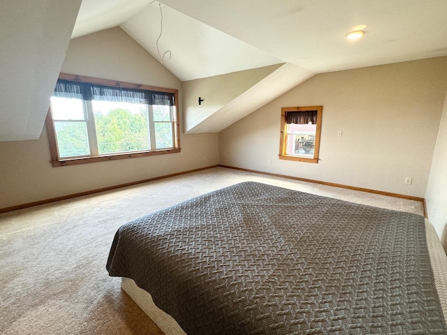 bonus room with lofted ceiling, carpet flooring, and baseboards