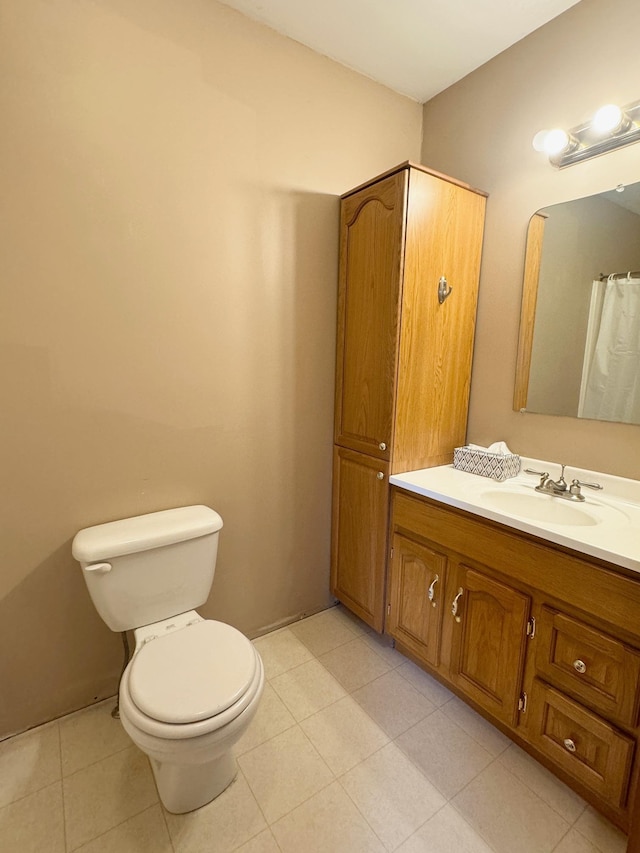 bathroom with vanity, toilet, and tile patterned floors