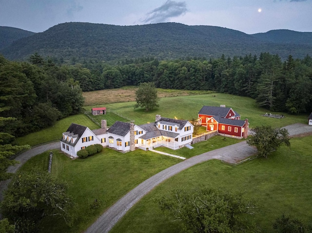 birds eye view of property with a forest view and a mountain view