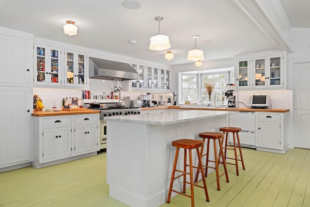 kitchen featuring white cabinets, extractor fan, white dishwasher, gas range, and decorative backsplash