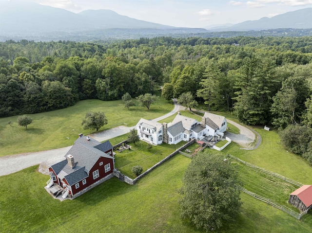 birds eye view of property featuring a mountain view and a wooded view