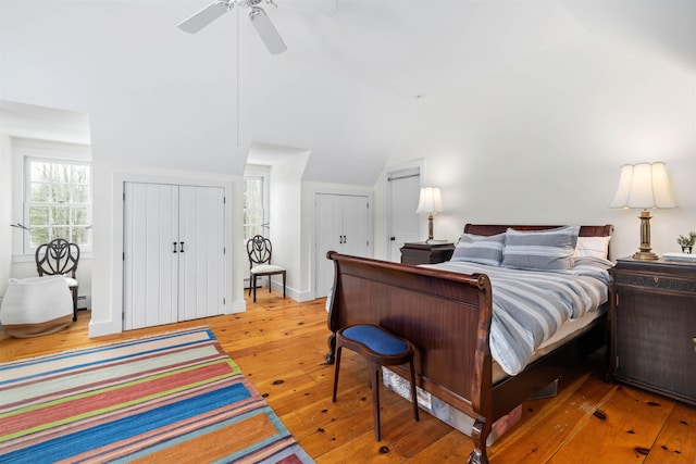 bedroom featuring vaulted ceiling and light wood-style flooring