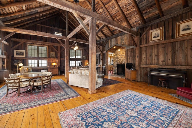 interior space with wooden ceiling, wood walls, a fireplace, and wood-type flooring