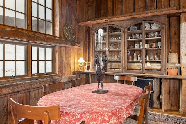 dining room featuring wood walls