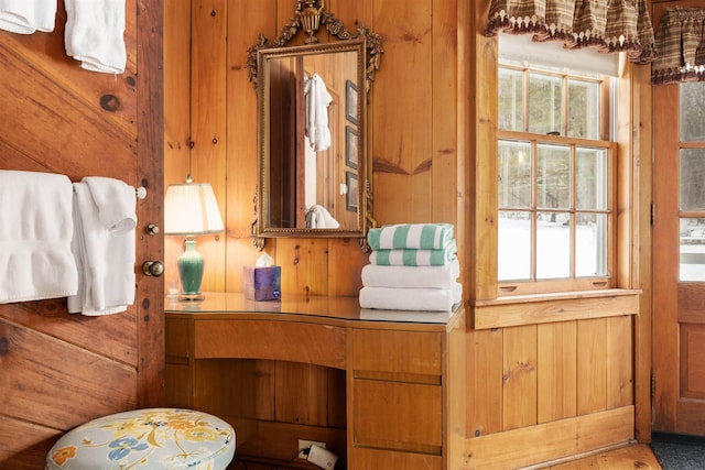 bathroom with vanity and wooden walls