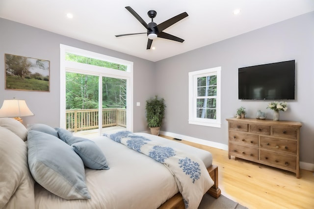 bedroom featuring light wood-style floors, multiple windows, recessed lighting, and access to exterior