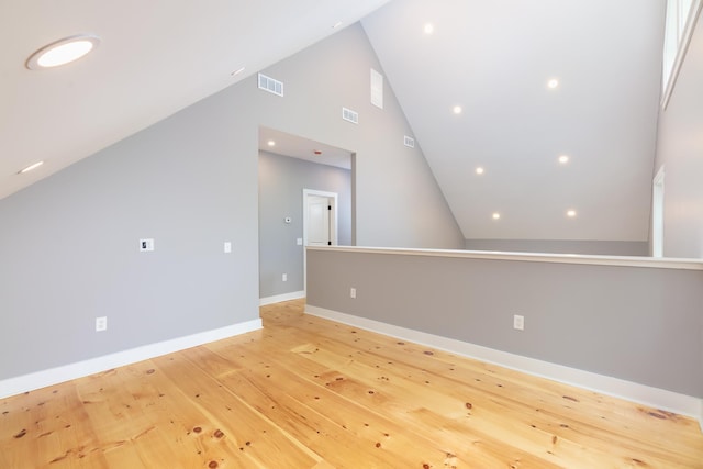 bonus room with high vaulted ceiling, light wood-style flooring, visible vents, and baseboards