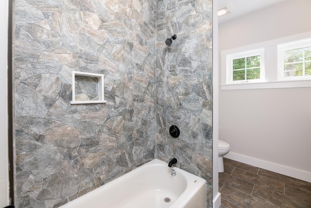 full bathroom featuring shower / washtub combination, baseboards, and toilet