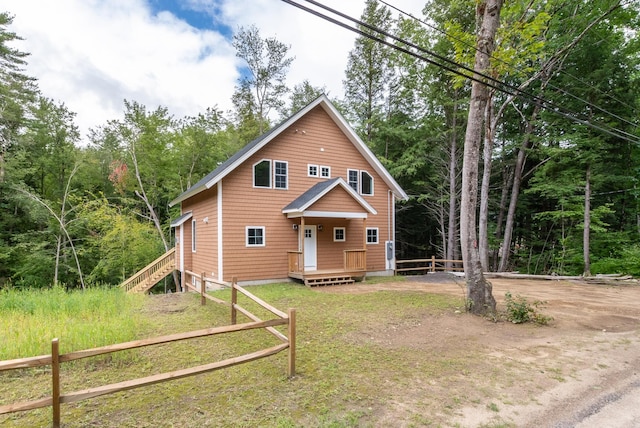 rustic home featuring fence