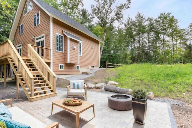 back of property featuring stairs, an outdoor fire pit, a patio area, and a wooden deck