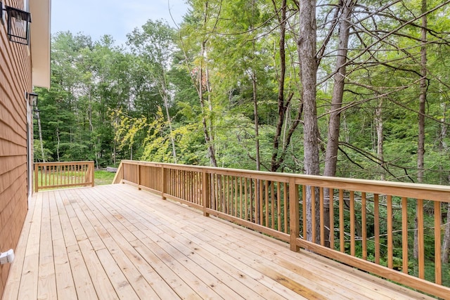 wooden terrace with a wooded view