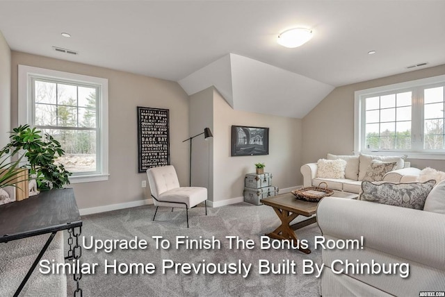 living room featuring carpet flooring, vaulted ceiling, and a wealth of natural light