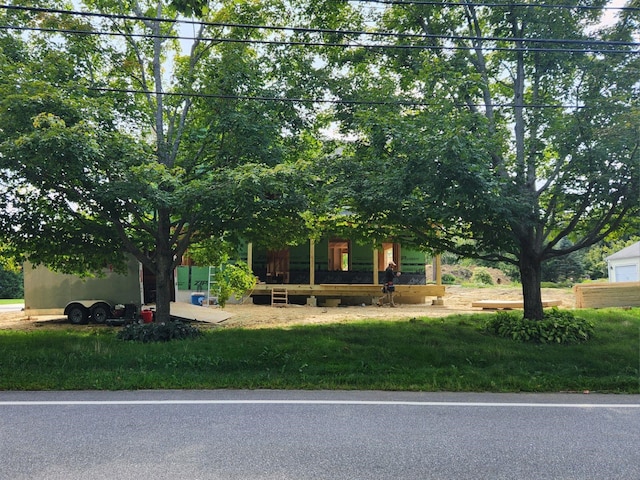 obstructed view of property featuring a front yard