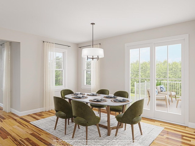 dining space with light wood-type flooring and baseboards