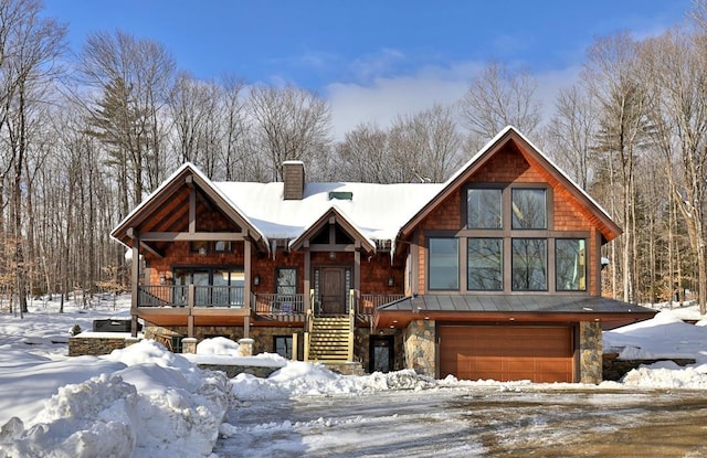 rustic home featuring a garage, stone siding, stairs, and a chimney