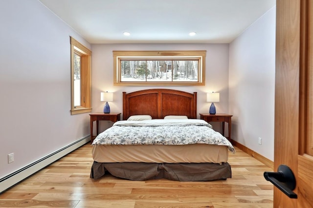 bedroom with light wood-style floors, recessed lighting, baseboards, and baseboard heating