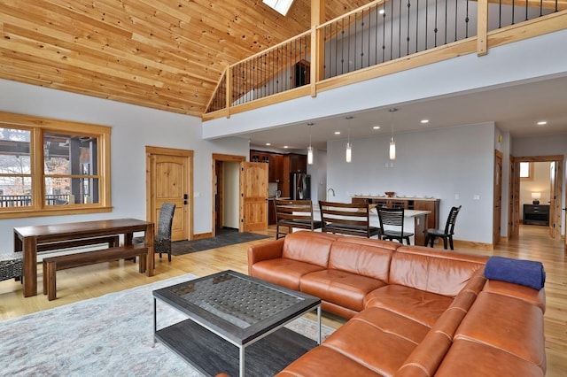 living area featuring baseboards, wood ceiling, wood finished floors, high vaulted ceiling, and recessed lighting