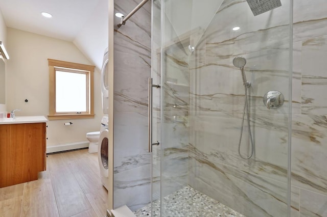 full bath featuring toilet, vanity, a marble finish shower, and wood finished floors