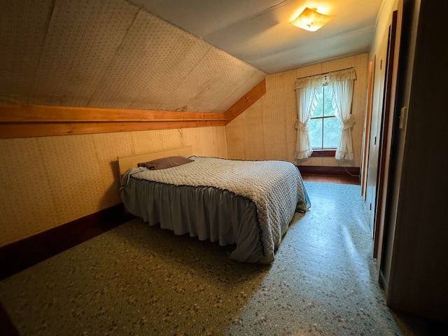 carpeted bedroom featuring lofted ceiling