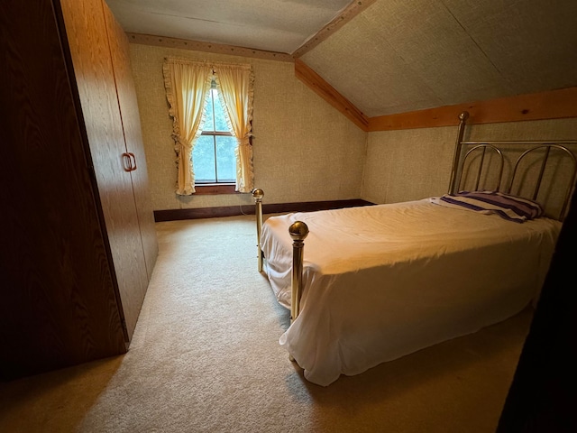 carpeted bedroom with vaulted ceiling