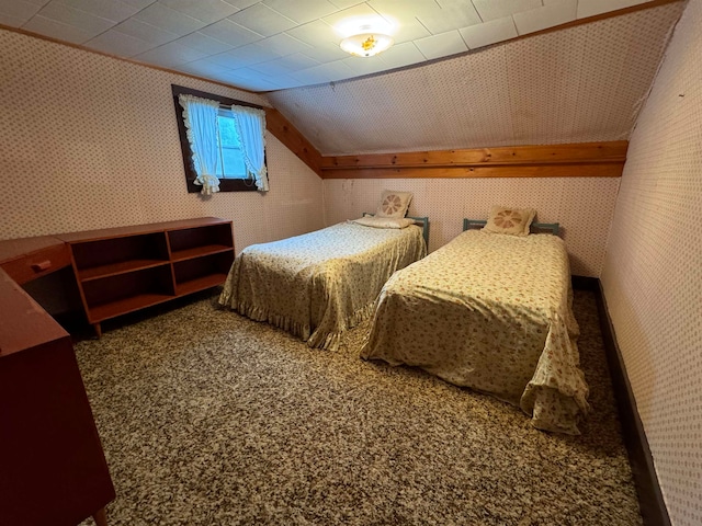 carpeted bedroom with lofted ceiling