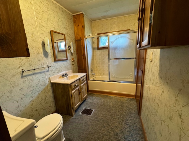 full bathroom featuring vanity, toilet, and enclosed tub / shower combo