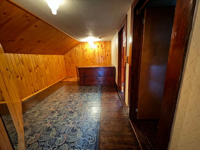 corridor with wood walls and dark hardwood / wood-style floors