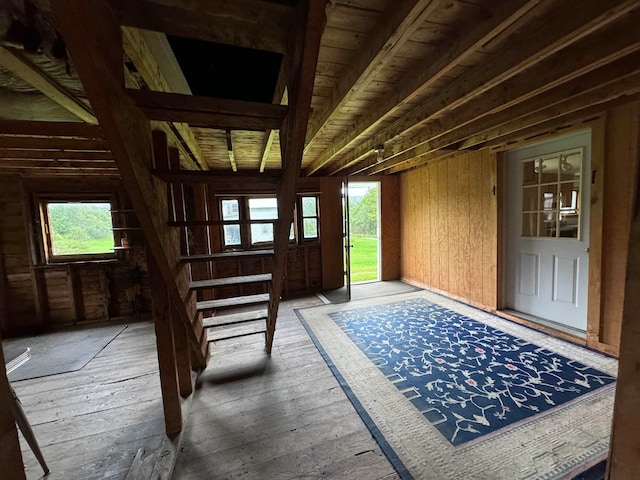 interior space with hardwood / wood-style floors and wooden walls