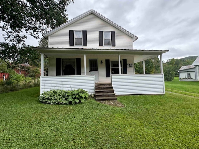 farmhouse with a front yard and covered porch