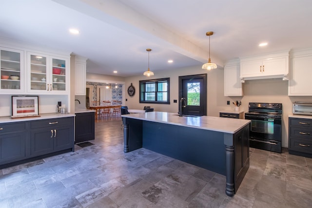 kitchen with black electric range, light countertops, glass insert cabinets, white cabinets, and a sink