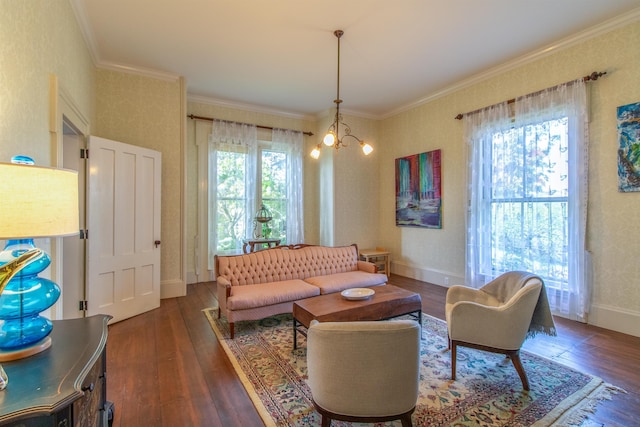 living area with ornamental molding, baseboards, an inviting chandelier, and wood finished floors