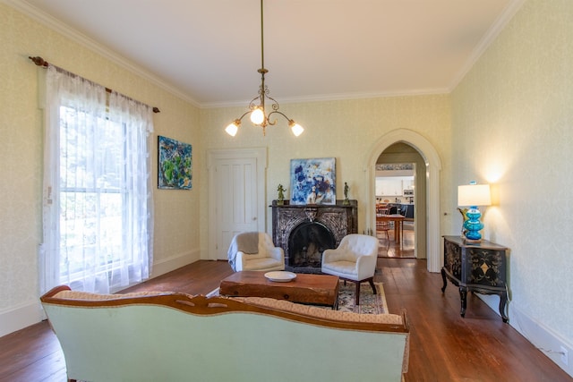 sitting room featuring plenty of natural light, a fireplace, arched walkways, and dark wood-type flooring