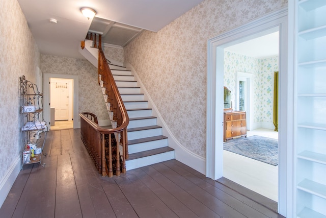 stairs featuring wallpapered walls, baseboards, and hardwood / wood-style flooring