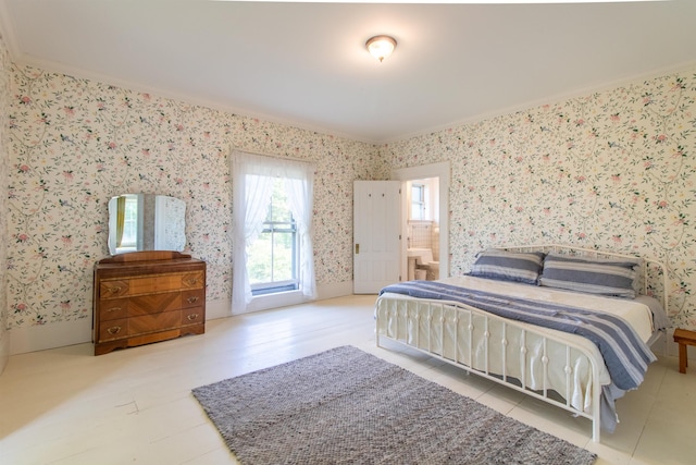 bedroom featuring ornamental molding and wallpapered walls