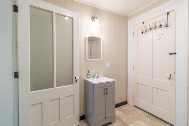 bathroom with ornamental molding and vanity