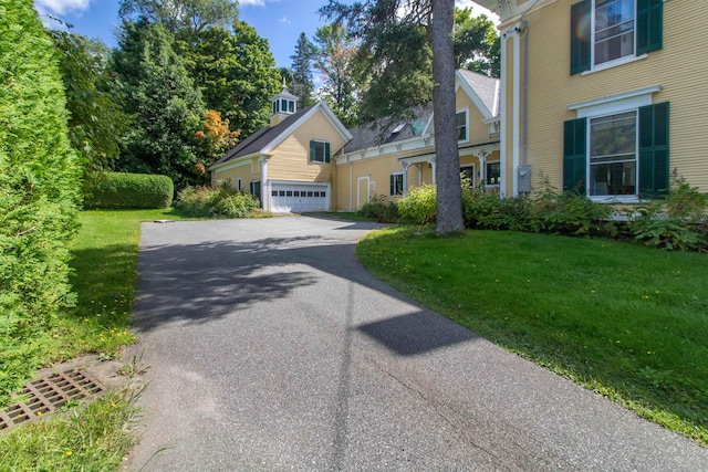 view of front of house featuring a garage and a front yard