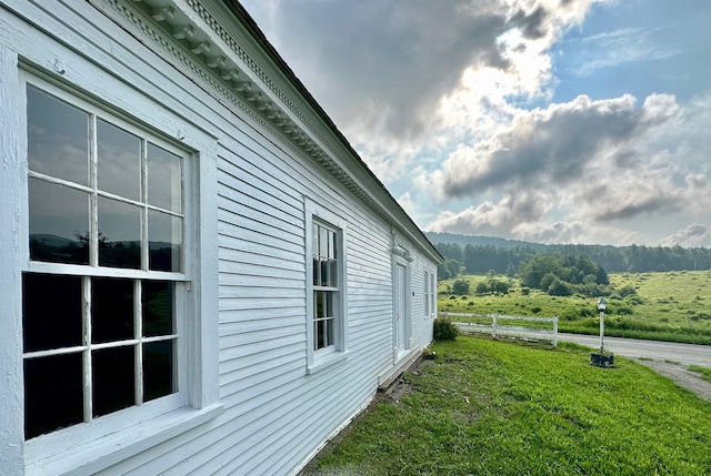 view of side of home featuring a yard