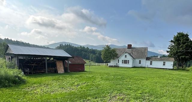 view of yard with a mountain view and an outbuilding