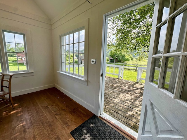 entryway with dark hardwood / wood-style floors and vaulted ceiling