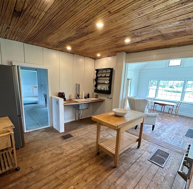 living room with light hardwood / wood-style floors and wood ceiling