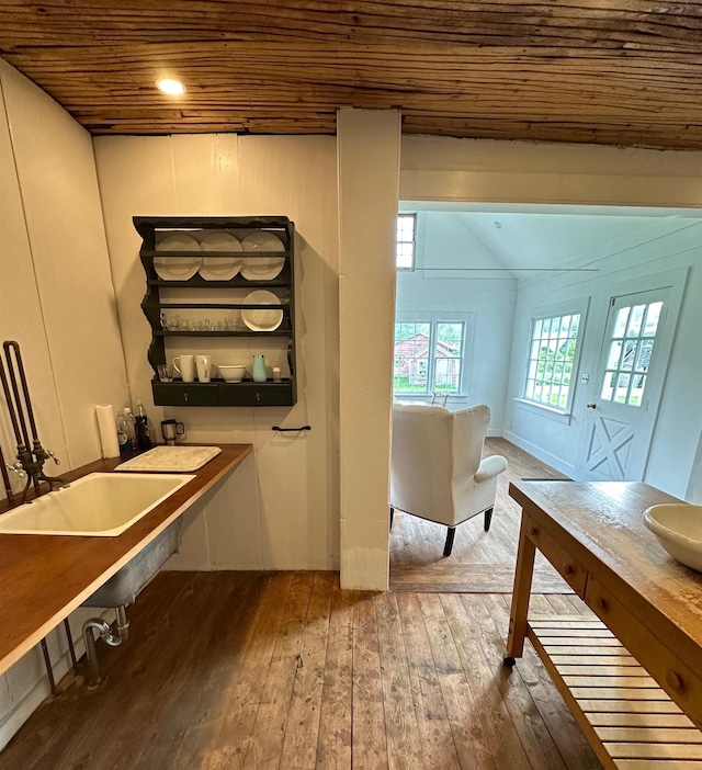 interior space featuring wood ceiling, hardwood / wood-style flooring, sink, and vaulted ceiling