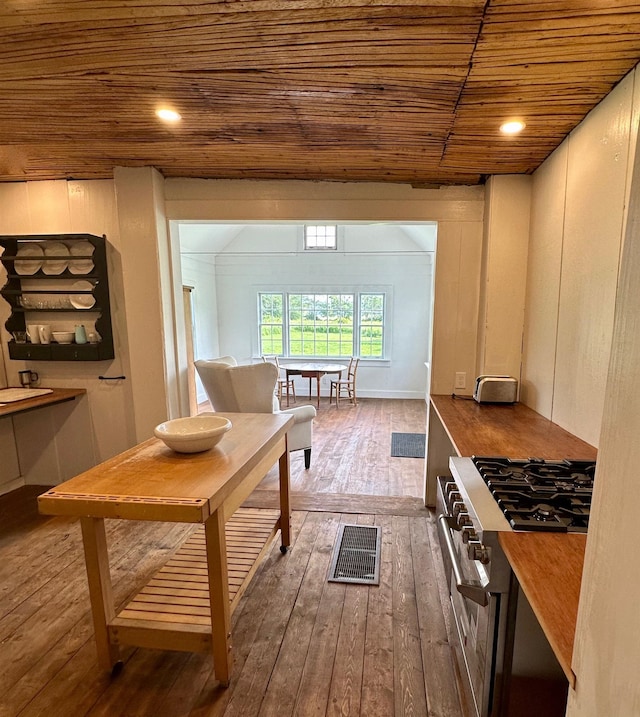 kitchen featuring wood ceiling, wood-type flooring, and high end range