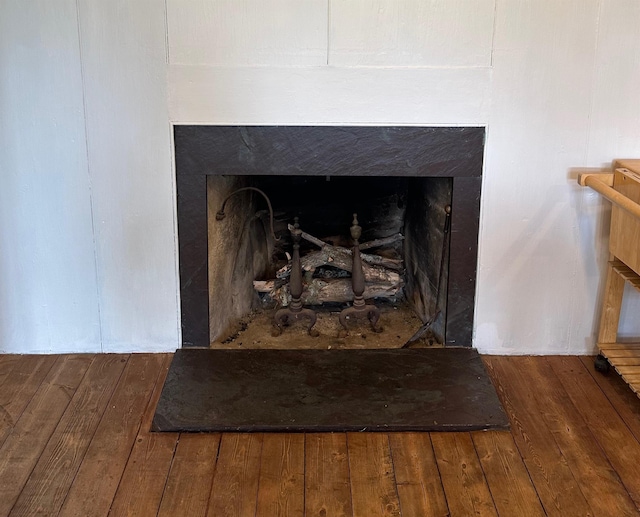 interior details featuring a high end fireplace and wood-type flooring